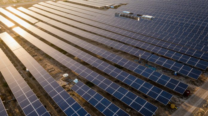 Large solar power plant with energy storage systems at sunset